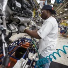 A worker installs parts on a Chrysler SUV engine at the Jefferson North Assembly Plant in Detroit. Plants in the U.S. are now operating above 90 percent capacity, but automakers are wary of adding large numbers of new workers.