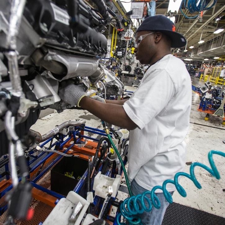 A worker installs parts on a Chrysler SUV engine at the Jefferson North Assembly Plant in Detroit. Plants in the U.S. are now operating above 90 percent capacity, but automakers are wary of adding large numbers of new workers.