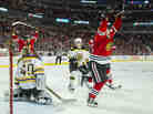 The thrill of victory; the agony of defeat: Andrew Shaw of the Chicago Blackhawks (right) celebrates after the game-winning goal goes in. Boston Bruins goaltender Tuukka Rask  looks back toward the puck that's now in his net.