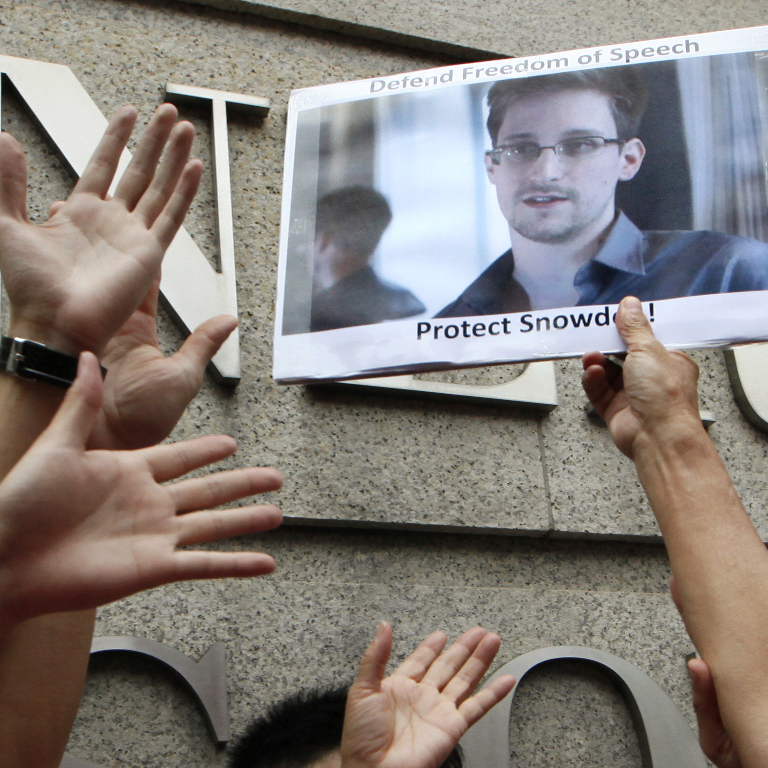 A supporter holds a picture of Edward Snowden, a former CIA employee who leaked top-secret information about U.S. surveillance programs, outside the U.S. Consulate General in Hong Kong on June 13.