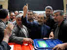 Ali Akbar Velayati, a conservative presidential candidate, shows his ink-stained finger as he votes at a polling station on Friday. Ali Akbar Velayati, a conservative presidential candidate, shows his ink-stained finger as he votes at a polling station on Friday.