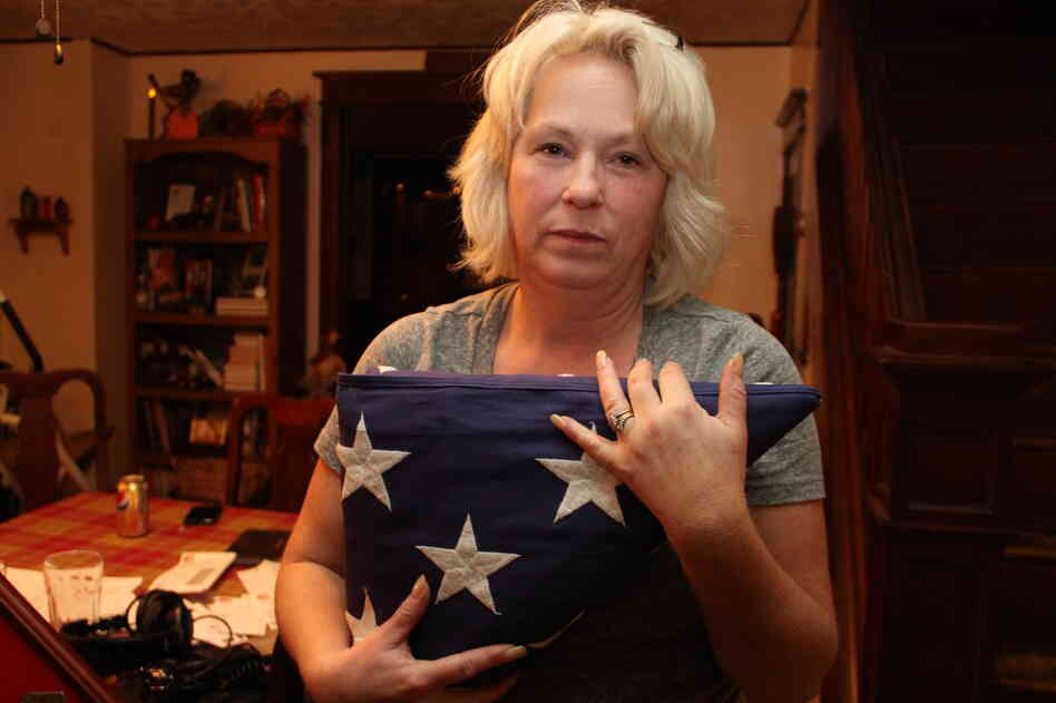 Anna holds the flag that was draped over Nick's coffin at his memorial service. She and her husband, Michael, have created a shrine to Nick in their dining room. Anna holds the flag that was draped over Nick's coffin at his memorial service. She and her husband, Michael, have created a shrine to Nick in their dining room.