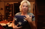 Anna holds the flag that was draped over Nick's coffin at his memorial service. She and her husband, Michael, <a href=