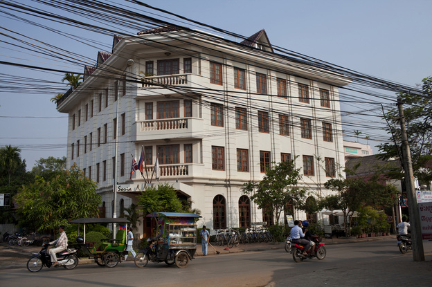 Traffic passes in front of the Soria Moria Boutique Hotel in Siem Reap, Cambodia. (Image credit: Will Baxter for NPR)