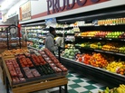 A customer in the produce section at Metro Foodland, one of the Detroit grocery stores participating in a healthy food incentive program for people with SNAP benefits. The store will add a section of specially marked local produce as part of the program. A customer in the produce section at Metro Foodland, one of the Detroit grocery stores participating in a healthy food incentive program for people with SNAP benefits. The store will add a section of specially marked local produce as part of the program.