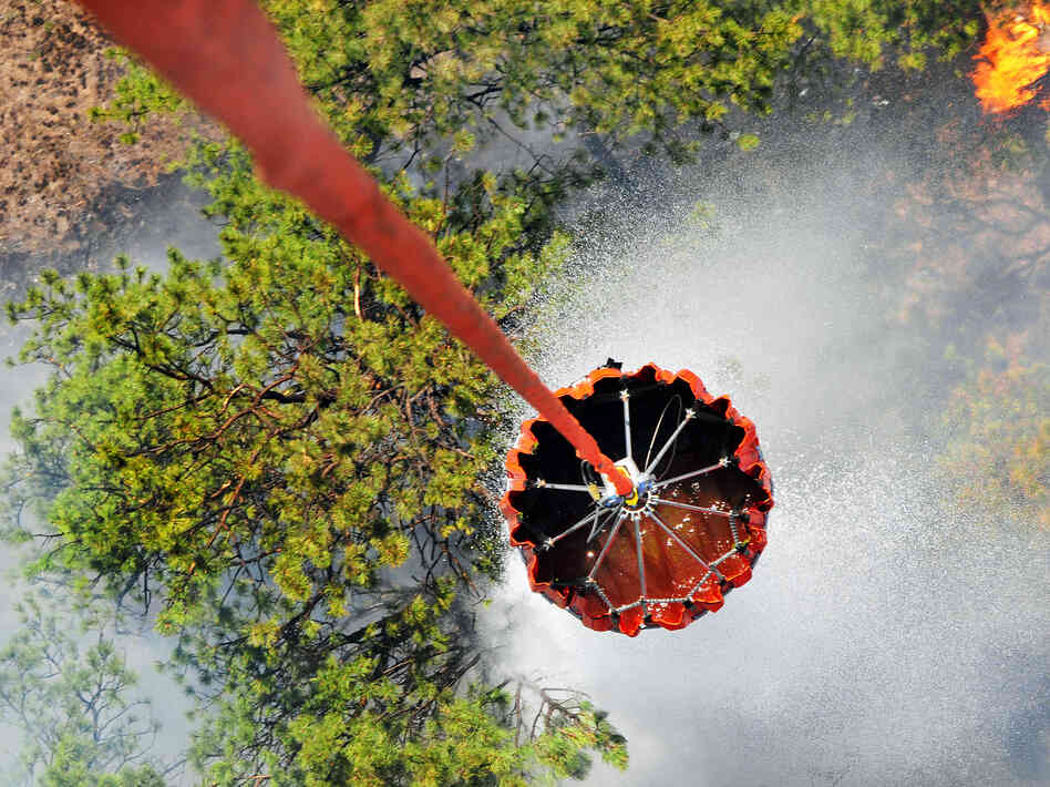 A U.S. Army helicopter releases water onto the Black Forest fire outside Colorado Springs, Colo., earlier this week. A U.S. Army helicopter releases water onto the Black Forest fire outside Colorado Springs, Colo., earlier this week.