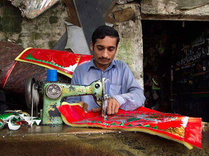 A young man stitches decorative seat covers and curtains in Rawalpindi, where he works for more than 12 hours a day. A young man stitches decorative seat covers and curtains in Rawalpindi, where he works for more than 12 hours a day.
