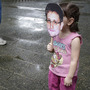 A young girl holds up a cutout image of Edward Snowden's face at the start of a rally in support of the NSA leaker over the weekend in Hong Kong.