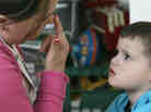 Instructional assistant Jessica Reeder touches her nose to get Jacob Day, 3, who has autism, to focus his attention on her during a therapy session in April 2007. Instructional assistant Jessica Reeder touches her nose to get Jacob Day, 3, who has autism, to focus his attention on her during a therapy session in April 2007.