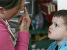 Instructional assistant Jessica Reeder touches her nose to get Jacob Day, 3, who has autism, to focus his attention on her during a therapy session in April 2007. Instructional assistant Jessica Reeder touches her nose to get Jacob Day, 3, who has autism, to focus his attention on her during a therapy session in April 2007.