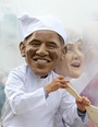 Oxfam charity volunteers wear masks depicting G-8 leaders President Obama and German Chancellor Merkel around a large caldron to draw attention to the issue of world hunger in Northern Ireland on Sunday. G-8 leaders are gathering there for an annual summit.