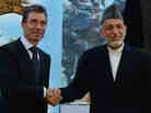 Afghan President Hamid Karzai shakes hands with NATO Secretary-General Anders Fogh Rasmussen after a security handover ceremony at a military academy outside Kabul on Tuesday.