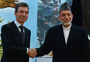 Afghan President Hamid Karzai shakes hands with NATO Secretary-General Anders Fogh Rasmussen after a security handover ceremony at a military academy outside Kabul on Tuesday.
