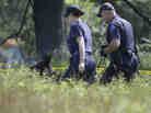 Law enforcement officials search an area in Oakland Township, Mich., on Tuesday for the remains of Jimmy Hoffa. The former Teamsters president was last seen at a Detroit-area restaurant in 1975.