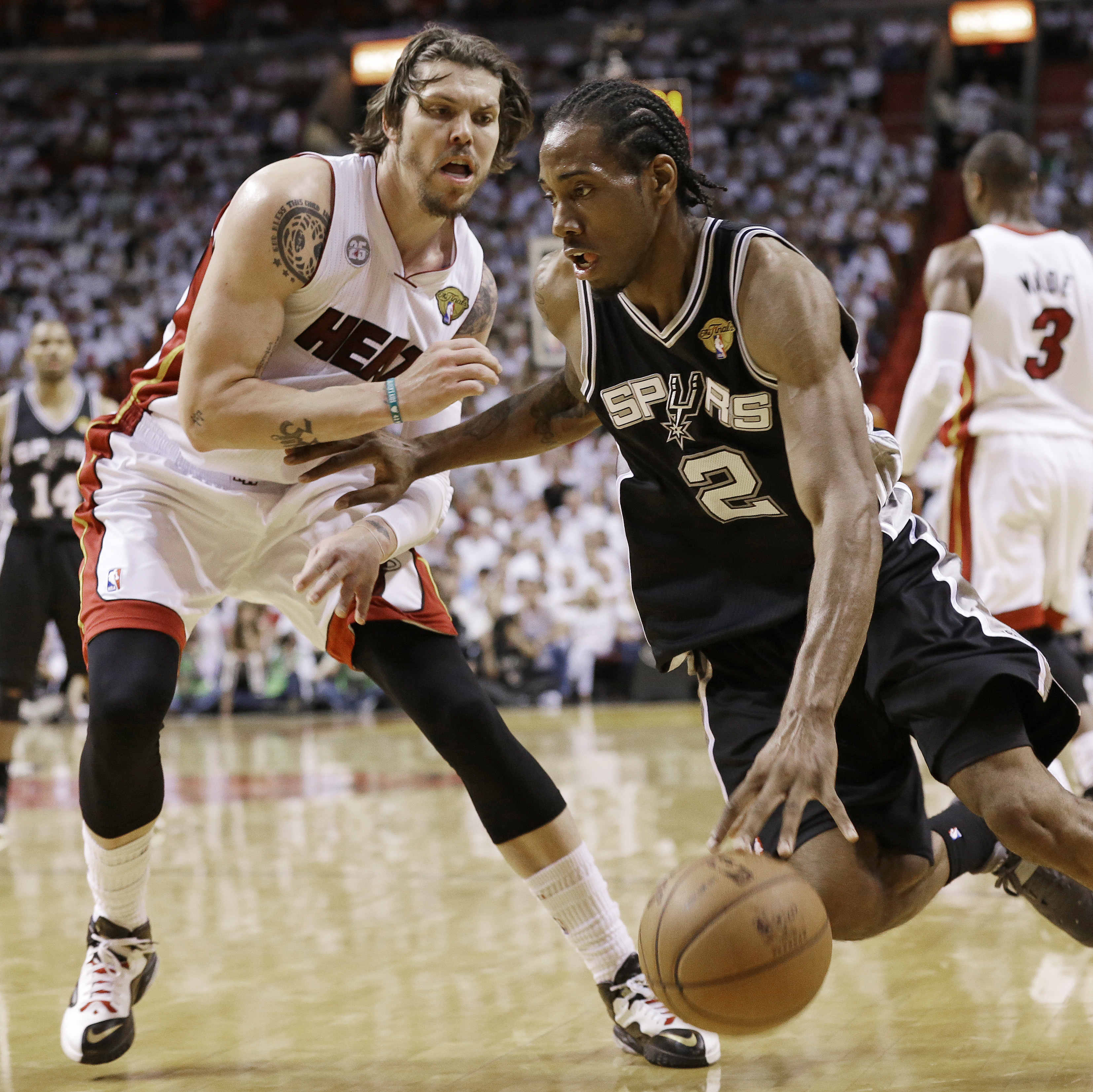 Miami Heat shooting guard Mike Miller (13) looks on as San Antonio Spurs small forward Kawhi Leonard (2) moves the ball during the second half of Game 6 of the NBA Finals basketball game on Tuesday.