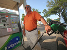 Jim White of Pennsylvania pumps gas at a BP station in Ocala, Fla., in April. The price of gasoline remains stubbornly high, which may put a crimp on summer travel plans. Jim White of Pennsylvania pumps gas at a BP station in Ocala, Fla., in April. The price of gasoline remains stubbornly high, which may put a crimp on summer travel plans.