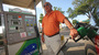 Jim White of Pennsylvania, pumps gas at a BP station in Ocala, Fla., in April. The price of gasoline remains stubbornly high, which may put a crimp on summer travel plans.