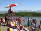 In this photo taken on Monday, people swim and sunbathe at Goose Lake in Anchorage, Alaska. In this photo taken on Monday, people swim and sunbathe at Goose Lake in Anchorage, Alaska.