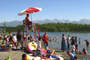 In this photo taken on Monday, people swim and sunbathe at Goose Lake in Anchorage, Alaska.