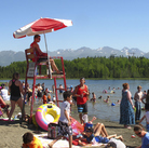 In this photo taken on Monday, people swim and sunbathe at Goose Lake in Anchorage, Alaska. In this photo taken on Monday, people swim and sunbathe at Goose Lake in Anchorage, Alaska.