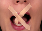 A woman with tape over her mouth. A woman with tape over her mouth.