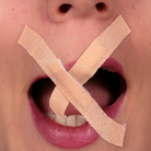 A woman with tape over her mouth.
