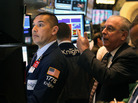 Traders work the floor of the New York Stock Exchange after the opening bell on Thursday. Traders work the floor of the New York Stock Exchange after the opening bell on Thursday.