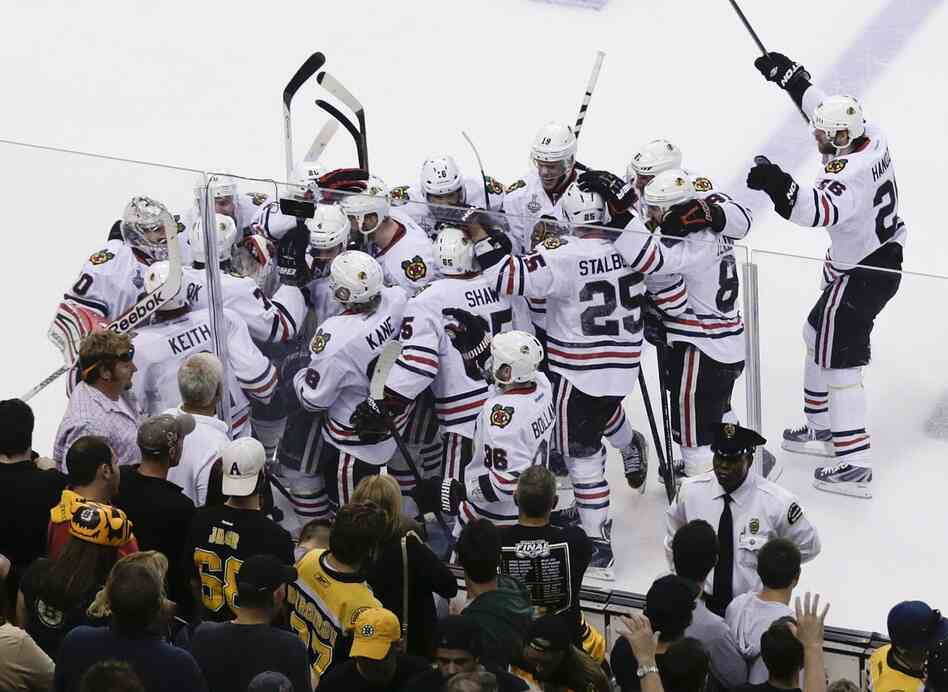 The Chicago Blackhawks mob Brent Seabrook after his gamewinning goal