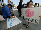 Gracie Shannon-Sanborn, 5, holds a sign as she joins her father Allen Sanborn (L) and members of Progressive Democrats of America at a rally in front of Rep. Henry Waxman's office on June 17, 2013 in Los Angeles, Calif. The protestors asked the congressman to vote against a House farm bill, which was defeated Thursday. Gracie Shannon-Sanborn, 5, holds a sign as she joins her father Allen Sanborn (L) and members of Progressive Democrats of America at a rally in front of Rep. Henry Waxman's office on June 17, 2013 in Los Angeles, Calif. The protestors asked the congressman to vote against a House farm bill, which was defeated Thursday.