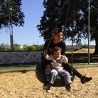 Micaela Torres and 2-year-old Jakai Johnson swing underneath a surveillance camera at Miwok Park in Elk Grove, Calif. The city's police department collects more than 100 video feeds from across the city.