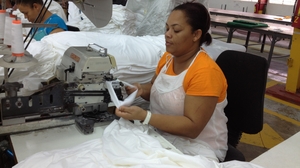 Aracelis Upia Montero works at the Alta Gracia garment factory in the Dominican Republic. She says she was desperately poor before she began working at the factory, which pays much higher than usual wages. "I'm now eligible for loans and credits from the bank because I earn a good salary," she says. Aracelis Upia Montero works at the Alta Gracia garment factory in the Dominican Republic. She says she was desperately poor before she began working at the factory, which pays much higher than usual wages. "I'm now eligible for loans and credits from the bank because I earn a good salary," she says.