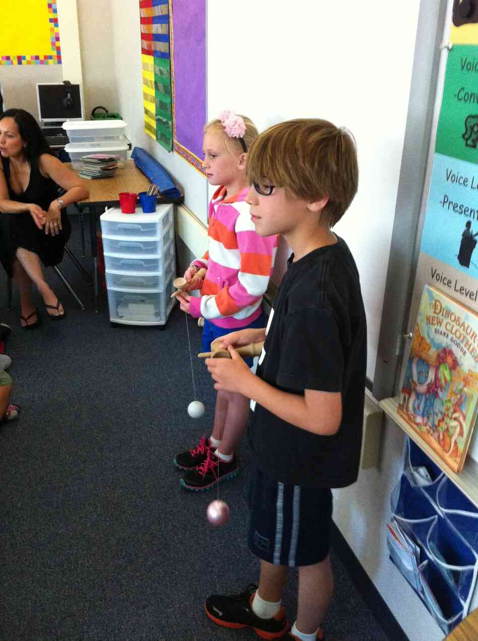 Nine-year-old Logan Tosta and his sister, Avery, show a class of second-graders at Michael J. Castori Elementary School in Sacramento, Calif. how to play with a kendama. Nine-year-old Logan Tosta and his sister, Avery, show a class of second-graders at Michael J. Castori Elementary School in Sacramento, Calif. how to play with a kendama.