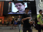 A TV screen shows a news report of Edward Snowden at a shopping mall in Hong Kong on Sunday. A TV screen shows a news report of Edward Snowden at a shopping mall in Hong Kong on Sunday.