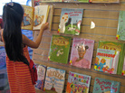 At a San Jose, Calif. library, a young reader browses a shelf of books featuring a variety of main characters: ducks, hens, white kids, black kids. Libraries help drive demand for children's books with nonwhite characters, but book publishers say there aren't enough libraries to make those books best-sellers. At a San Jose, Calif. library, a young reader browses a shelf of books featuring a variety of main characters: ducks, hens, white kids, black kids. Libraries help drive demand for children's books with nonwhite characters, but book publishers say there aren't enough libraries to make those books best-sellers.