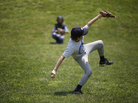 Harry Kaplan practices pitching during Home Run Baseball Camp at Friendship Recreation Center in June. Kaplan's arm is stretched long and toward the ground as his hips are faced away from the catcher. A chimp, in contrast, could never throw a fastball. Harry Kaplan practices pitching during Home Run Baseball Camp at Friendship Recreation Center in June. Kaplan's arm is stretched long and toward the ground as his hips are faced away from the catcher. A chimp, in contrast, could never throw a fastball.