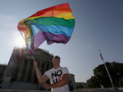 Gay rights activist Vin Testa of DC waves a flag outside the U.S. Supreme Court building on Tuesday in Washington, DC. Gay rights activist Vin Testa of DC waves a flag outside the U.S. Supreme Court building on Tuesday in Washington, DC.