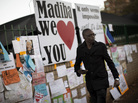 A well-wisher walks in front of a wall in Pretoria covered with messages for ailing former South African President Nelson Mandela on Wednesday. A well-wisher walks in front of a wall in Pretoria covered with messages for ailing former South African President Nelson Mandela on Wednesday.