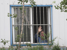 American Chip Starnes, co-owner of Specialty Medical Supplies, waves Monday from a window where he is being held by angry workers inside his plant at the Jinyurui Science and Technology Park on the outskirts of Beijing. He remained confined to the plant on Wednesday. American Chip Starnes, co-owner of Specialty Medical Supplies, waves Monday from a window where he is being held by angry workers inside his plant at the Jinyurui Science and Technology Park on the outskirts of Beijing. He remained confined to the plant on Wednesday.
