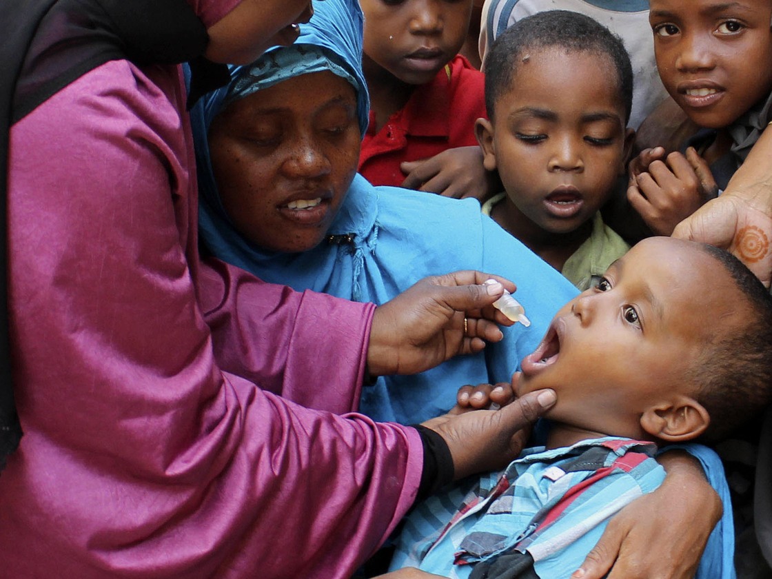 Health workers vaccinate a boy against polio at a May immunization drive in Mogadishu, Somalia. Health workers vaccinate a boy against polio at a May immunization drive in Mogadishu, Somalia.