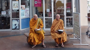 Buddhist monks sit outside a Zen Mobile store in southwest Houston.