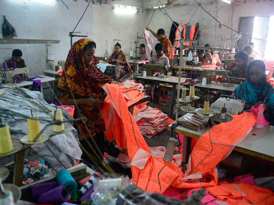 Bangladeshi workers in a small garments factory. Bangladeshi workers in a small garments factory.