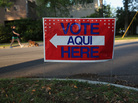 A bilingual sign stands outside a polling center at a public library ahead of local elections on April 28 in Austin, Texas. A bilingual sign stands outside a polling center at a public library ahead of local elections on April 28 in Austin, Texas.