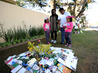 A family brings a message of good wishes for former South African President Nelson Mandela outside his house in Johannesburg Monday. Mandela, 94, is in critical but stable condition. A family brings a message of good wishes for former South African President Nelson Mandela outside his house in Johannesburg Monday. Mandela, 94, is in critical but stable condition.