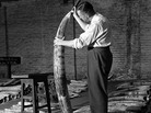 A man checks the quality of ivory stocks before an auction at the London docks in January 1948. A man checks the quality of ivory stocks before an auction at the London docks in January 1948.