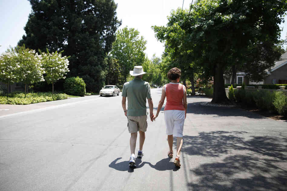 Robin and Anne Jones take a walk near their home. They say that an Alzheimer's biomarker test made it easier to plan for the future. Robin and Anne Jones take a walk near their home. They say that an Alzheimer's biomarker test made it easier to plan for the future.