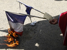 A man burns the French flag outside France's embassy in La Paz, Bolivia, Wednesday. Bolivia's President Evo Morales is returning home late today, after his plane was not allowed to fly in the airspace of France and other countries. A man burns the French flag outside France's embassy in La Paz, Bolivia, Wednesday. Bolivia's President Evo Morales is returning home late today, after his plane was not allowed to fly in the airspace of France and other countries.