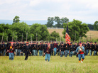 Men dressed as members of the Union infantry demonstrate battalion formations for tourists. Men dressed as members of the Union infantry demonstrate battalion formations for tourists.