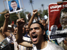 An Egyptian supporter of the Muslim Brotherhood and ousted President Mohammed Morsi protest near Cairo University on Friday. An Egyptian supporter of the Muslim Brotherhood and ousted President Mohammed Morsi protest near Cairo University on Friday.