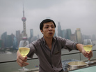 A waiter delivers glasses of wine to guests at a luxury hotel bar near the Bund in Shanghai, on Sept. 8, 2012. A waiter delivers glasses of wine to guests at a luxury hotel bar near the Bund in Shanghai, on Sept. 8, 2012.