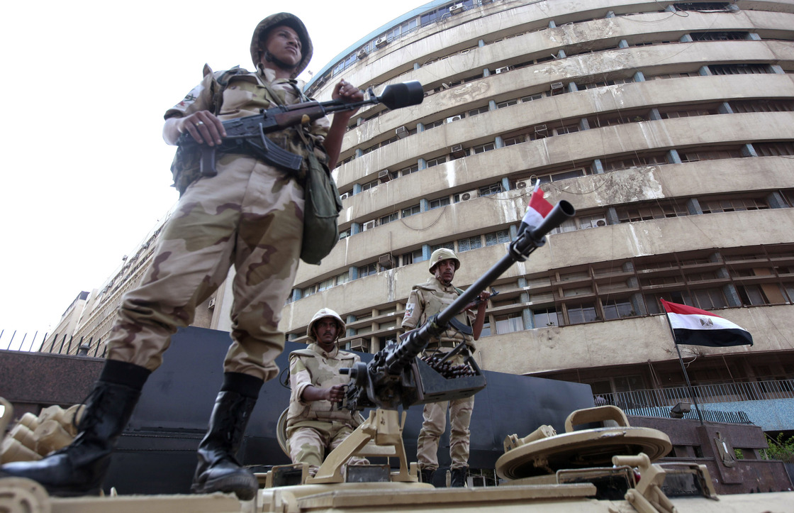 Soldiers stand on an armored personnel carrier positioned outside the state-run television station in Cairo, on July 6.